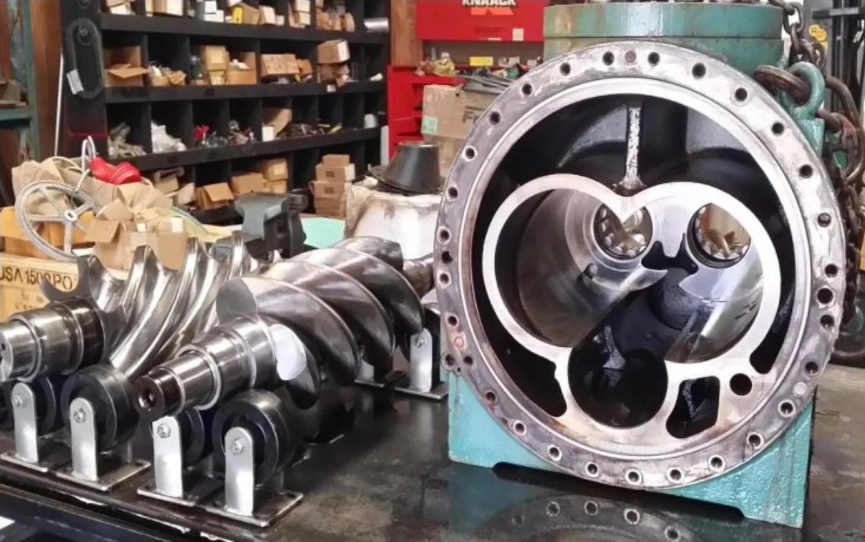 The rotor set beside its casing bore. Clearances are measured against the maker’s limits before anything goes back together.